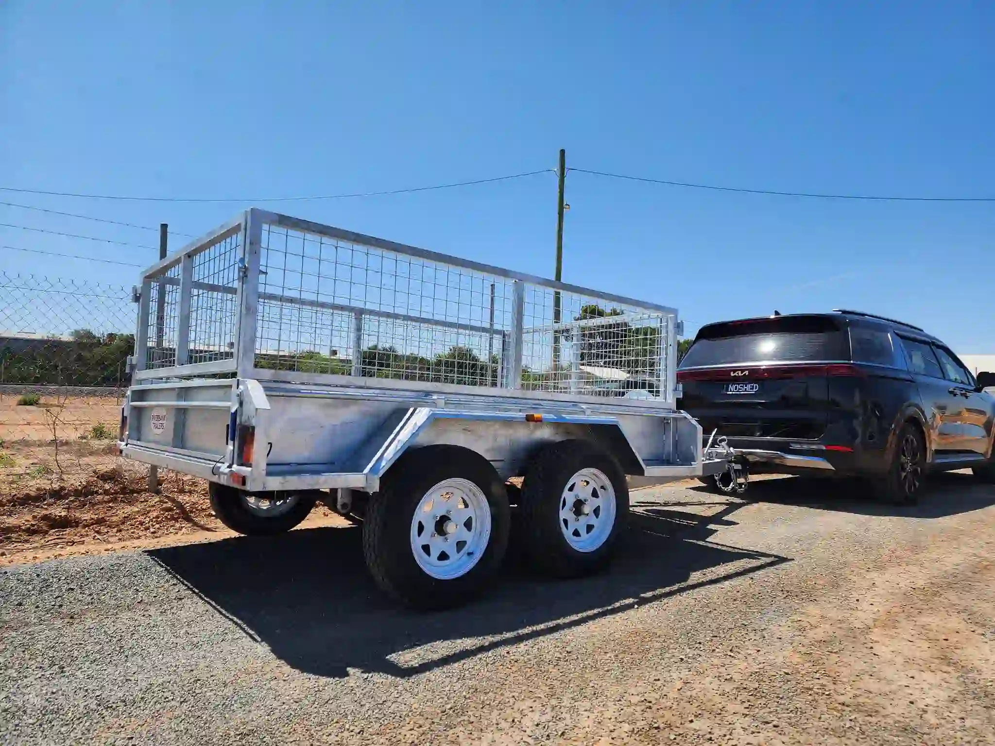 cage trailer towed black SUV